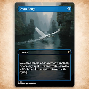 May include: A rectangular trading card titled Swan Song with a blue border. The artwork depicts a white swan taking flight over dark water between rocky cliffs. The text box reads: Counter target enchantment, instant, or sorcery spell. Its controller creates a 2/2 blue Bird creature token with flying.