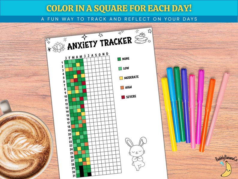 May include: A white Anxiety Tracker sheet with a grid for tracking emotions, accompanied by colorful markers. The sheet includes the text "COLOR IN A SQUARE FOR EACH DAY!" and "A FUN WAY TO TRACK AND REFLECT ON YOUR DAYS". A cup of coffee is in the background.