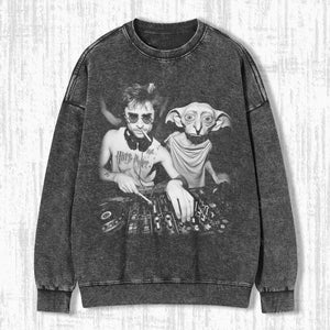 May include: A black and white graphic sweatshirt featuring a DJ scene with Harry Potter and Dobby. The design includes a DJ mixer and headphones. The sweatshirt has a washed, vintage look.