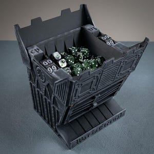 May include: A dark grey dice tower with a gothic design, filled with green dice. The tower features multiple compartments and the text "War is Eternal" on the base. Ideal for tabletop gaming, it's a functional and decorative piece.