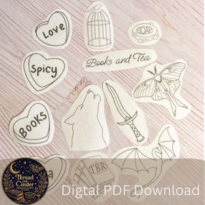 May include: A collection of black and white line art embroidery patterns featuring heart-shaped sweets with the words Love, Spicy, and Books, a birdcage, a bar of soap, a moth, a wolf, a sword, a dragon, and a stack of books labelled TBR.