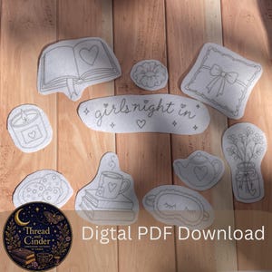 May include: A collection of white fabric patches featuring black line art embroidery designs including an open book, a scrunchie, a pillow with a bow, a candle, a teapot, a mug on books, a sleep mask, flowers in a jar, cookies, and the text girls night in.