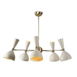 May include: A mid-century modern chandelier with six off-white cone-shaped shades. The light fixture has a brass-coloured frame and a gold-coloured ceiling mount. The shades are angled and have small perforations near the bottom, and the interior of the shades are illuminated.