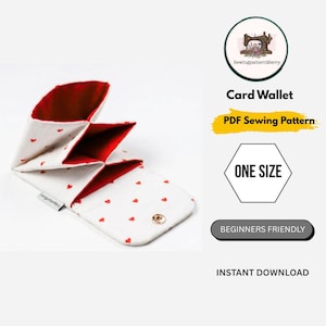 May include: White card wallet with red heart pattern and red interior, open to display multiple compartments. The wallet is secured with a snap closure. Text on the image reads "Card Wallet", "PDF Sewing Pattern", "One Size", "Beginners Friendly", and "Instant Download".