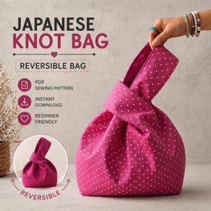 May include: A pink Japanese knot bag with white polka dots. The bag is reversible and features a knotted handle. The image also includes text that reads "Japanese Knot Bag" and "Reversible Bag".
