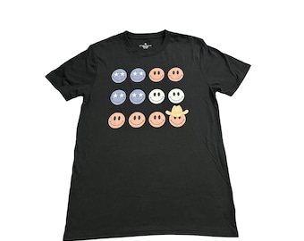 Camiseta negra con estampado gráfico de cara sonriente, vaquero y ojos de estrella para hombre, talla M, en excelente estado.