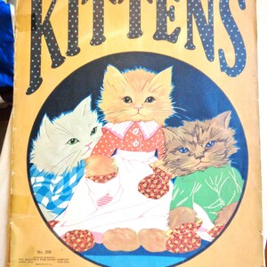 May include: Vintage book cover titled "KITTENS" with three illustrated kittens inside a blue circle. The title is in large, dotted letters. The kittens wear dresses and shirts. The background is yellow.