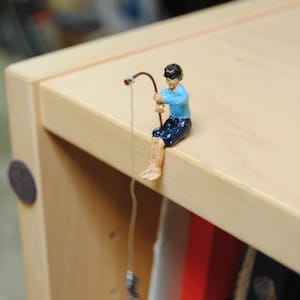 May include: A set of three ceramic mugs with a speckled, matte finish. Each mug features a different color: light blue, cream, and gray. The mugs have a simple, modern design and a comfortable handle.