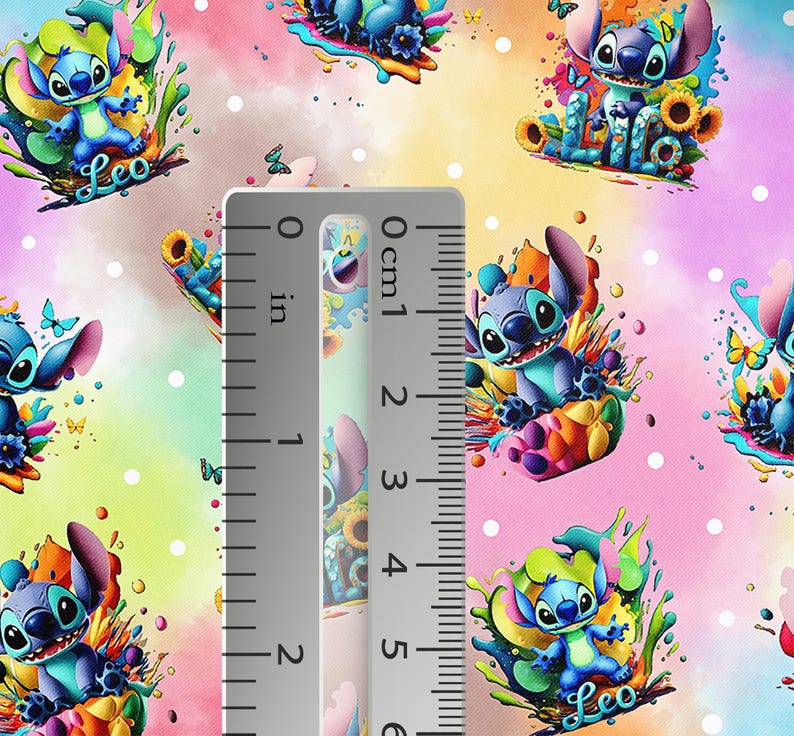 May include: Colorful fabric featuring a repeating pattern of the character Stitch from Lilo & Stitch. The blue character is surrounded by sunflowers, butterflies, and splashes of color. The ruler shows approximately 2 inches.