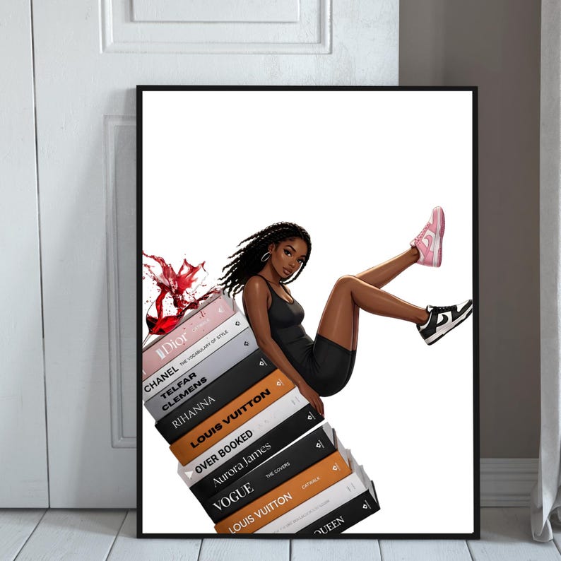 May include: A framed art print featuring a stylish illustration of a person in a black outfit, leaning against a stack of fashion books. The books include titles like Dior, Chanel, and Louis Vuitton. The person is wearing pink and black sneakers. A splash of red liquid is seen.