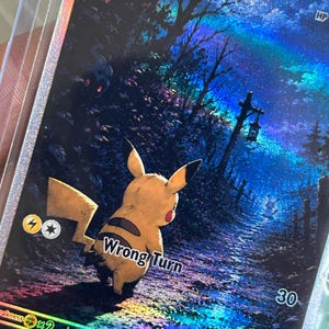 May include: A holographic trading card featuring a yellow Pikachu standing on a dark, wet forest path at night. The card displays the text Pikachu, Wrong Turn, and 30, with a glowing blue sky, a hanging lantern, and a small silhouette in the distance.