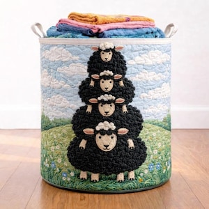 May include: A round laundry hamper with a whimsical design. The exterior features a stacked sheep design against a backdrop of a blue sky and green field. The hamper is filled with folded towels and has two handles.