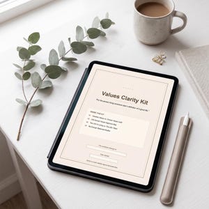 May include: A digital tablet displaying a Values Clarity Kit workbook with a beige background. The text reads Values Clarity Kit, For the person living someone else's definition of a good life, Inside this kit, and includes four numbered sections.