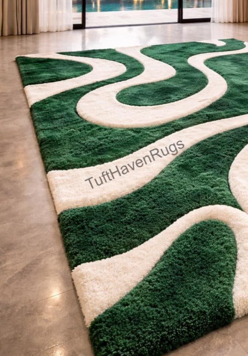 May include: A rectangular green and white area rug with a wavy design. The rug features a deep green background with flowing, cream-colored, wave-like patterns. The text "TuftHavenRugs" is visible on the rug.