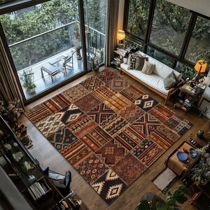May include: A large, rectangular rug with a patchwork design. The rug features geometric and tribal patterns in brown, navy, orange, and cream. It is placed on a wooden floor in a living room. The rug's dimensions are approximately 300 cm x 200 cm.