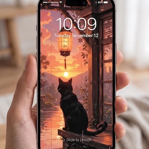 May include: Smartphone screen displaying a digital illustration of a black cat sitting on a wooden ledge, overlooking a sunset scene. A Japanese lantern hangs from the wooden structure. The time is 10:09, Tuesday, November 12.