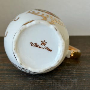 May include: A set of three ceramic mugs with a speckled, matte finish. Each mug features a different color: light blue, cream, and gray. The mugs have a simple, modern design and a comfortable handle.