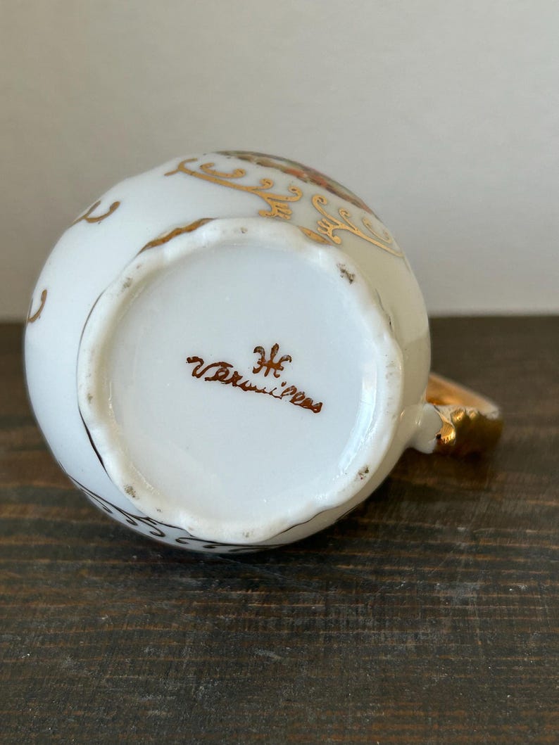 May include: A set of three ceramic mugs with a speckled, matte finish. Each mug features a different color: light blue, cream, and gray. The mugs have a simple, modern design and a comfortable handle.