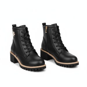 May include: Black leather combat boots with a block heel and a decorative flower. The boots feature a lace-up closure, a side zip, and a tan trim around the sole. The heel height is approximately 5 cm.