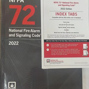 May include: A white ceramic mug with a black handle and the text "But First, Coffee" in a black, handwritten-style font. The mug is on a white surface.