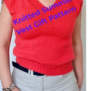 May include: A sleeveless, coral-red knitted vest with a V-neck. The vest has a ribbed hem and is paired with light gray pants and a black belt. Text on the vest reads "Knitted Summer Vest Gift Pattern".