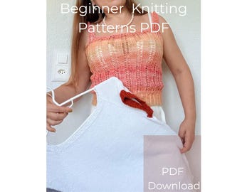 May include: A woman is holding a white knitted garment on a hanger, with a red knitted accent. She is wearing a knitted top in shades of orange and pink. The text "Beginner Knitting Patterns PDF" is visible.