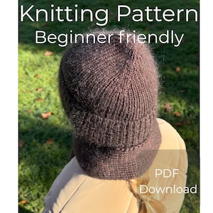 May include: A brown knitted hat, with a brim, is shown in the image. The text "Knitting Pattern Beginner friendly" is at the top of the image. The text "PDF Download" is at the bottom of the image.