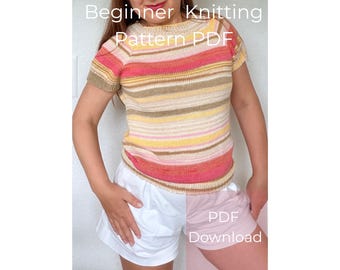 May include: A short-sleeved knitted top featuring horizontal stripes in shades of pink, orange, yellow, and beige. The text "Beginner Knitting Pattern PDF" and "PDF Download" is overlaid on the image of the garment with a round neckline.
