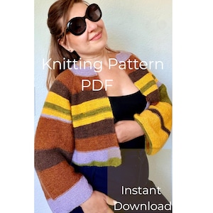 May include: A cropped, long-sleeved knit cardigan featuring horizontal stripes in shades of brown, yellow, olive green, and lavender. The garment has a round neckline and an open front. The text Knitting Pattern PDF and Instant Download is visible.