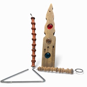 May include: A collection of musical instruments including a triangle, a wooden rattle, a wooden instrument with red, clear, and blue glass accents, and a red wooden instrument with a loop at the top.