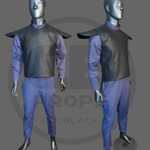 May include: Two mannequins showcase a costume. The outfit comprises a black vest with shoulder detailing, a long-sleeved blue shirt, and blue trousers. The mannequins stand against a grey backdrop. The costume is likely for cosplay or a theatrical performance.