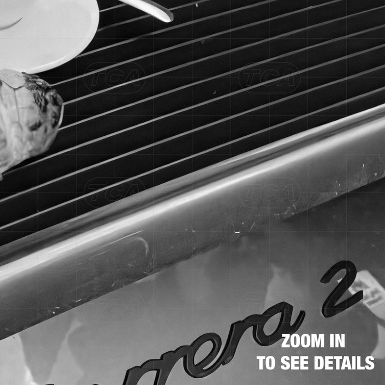 a close-up view of a camera lens, with the text "Zoom in to see details" visible.