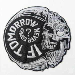 May include: Embroidered patch with a black background and white text. The patch features a skull design on the right side and the words "IF TOMORROW NEVER COMES?" in a circular pattern. A question mark is in the centre.