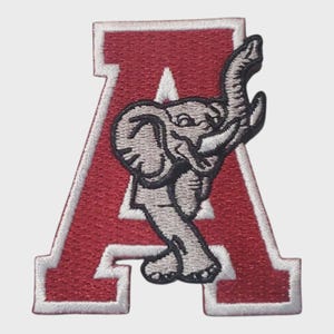 May include: Embroidered patch featuring a red letter "A" with a white border. A gray elephant with raised trunk is superimposed on the letter. The patch is likely for apparel or accessories, and is a collegiate or team emblem.