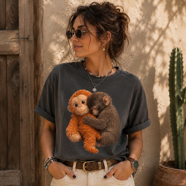 Emotional support monkey graphic printed on premium Comfort Colors shirts. Couple fashion mockup showcasing trendy vintage-style animal lover tees with soft earthy colors.