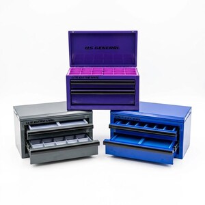 May include: Three small tool chests in purple, gray, and blue. Each chest has drawers and a top compartment. The purple chest is open, revealing dividers. The text "US GENERAL" is printed on each chest.
