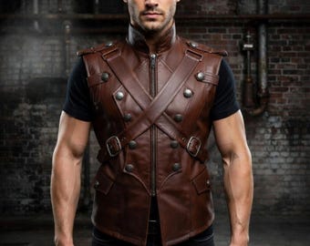 May include: Brown leather vest with a high collar, zipper closure, and decorative silver buttons. The vest features a cross-body strap design and small pockets. The vest is worn over a black t-shirt and paired with black jeans.
