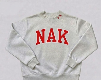 Heather Grey mockneck Sweatshirt having embroidery at Front as " NAK" and at collar " tr 26 "