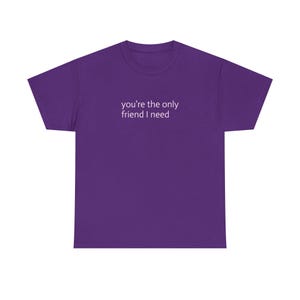 May include: A purple t-shirt with the text "you're the only friend I need" in white, centered on the chest. The shirt has short sleeves and a crew neck.