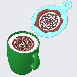 May include: A green coffee mug with a white and brown design on top, next to a light blue stencil with a matching design. The stencil is oval-shaped with a handle. The coffee art and stencil feature a geometric floral pattern.