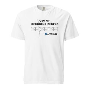 Pode incluir: Camiseta branca com o texto preto "CEO OF DECODING PEOPLE". O design inclui símbolos de código e uma marca de seleção "APPROVED". Um desenho a traço de um rosto também faz parte do design.