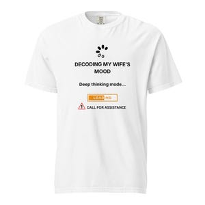 Può includere: T-shirt bianca con la scritta nera "DECODING MY WIFE'S MOOD". Sotto, le parole "Deep thinking mode..." e una barra di caricamento. Un segnale di avvertimento con le parole "CALL FOR ASSISTANCE" è in basso.