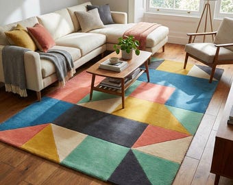 Puede incluir: Una colorida alfombra geométrica con un diseño moderno. La alfombra presenta grandes bloques y triángulos en tonos de azul, amarillo, coral, gris y crema. La alfombra está colocada sobre un suelo de madera en un salón.