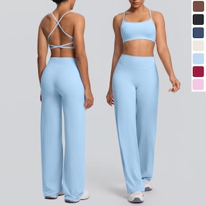May include: Pale blue activewear set comprising a sports bra with crisscross back straps and high-waisted wide-leg trousers. The set is made of a soft, stretchy material. A colour palette of brown, black, navy, beige, light blue, burgundy, and pink is shown.