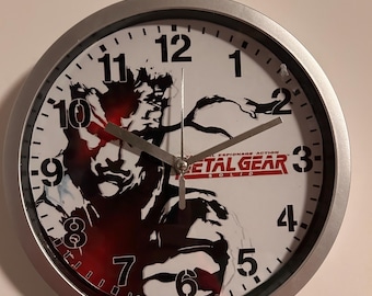 Orologio da parete Metal Gear Solid - 20 cm - Decorazione per videogiocatori per appassionati di Solid Snake