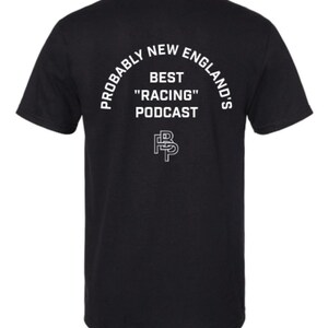 May include: Black t-shirt with white text. The text reads "Probably New England's Best "Racing" Podcast" in an arched layout. Below the text is a stylized "FP" logo.