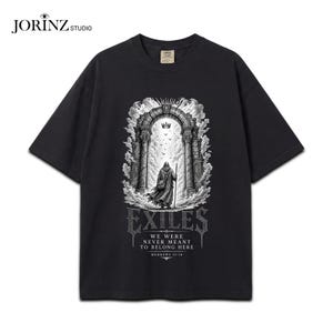 May include: A black short-sleeve t-shirt featuring a graphic print of a cloaked figure standing before a stone archway under a crown. The text reads EXILES, WE WERE NEVER MEANT TO BELONG HERE, and HEBREWS 13:14 in a white, gothic-style font.