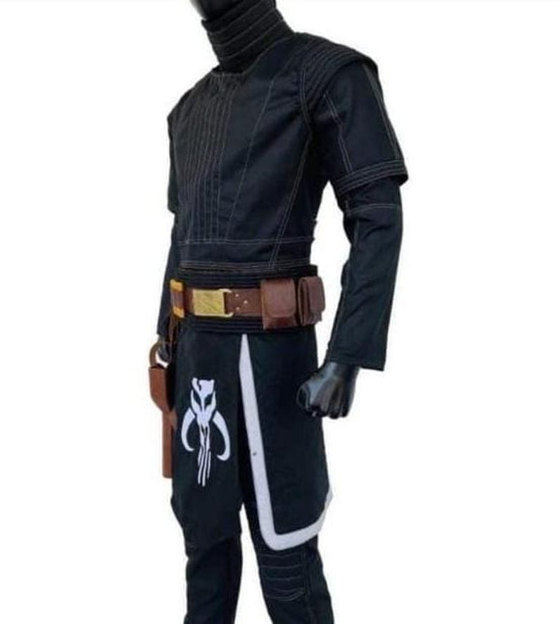 K&ouml;nnte beinhalten: Schwarzes Kost&uuml;m mit hohem Kragen, langen &Auml;rmeln und einem Werkzeugg&uuml;rtel mit Taschen. Die Hose hat ein wei&szlig;es und schwarzes Grafikdesign. Ein Holster ist am G&uuml;rtel befestigt. Das Kost&uuml;m wird auf einer Schaufensterpuppe pr&auml;sentiert.