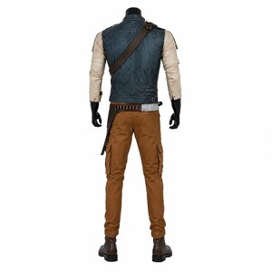 May include: A costume comprising a blue denim vest, tan long-sleeved shirt, brown cargo trousers, and a brown leather belt with a holster. The outfit includes a brown shoulder strap and brown boots. The mannequin wears black gloves.