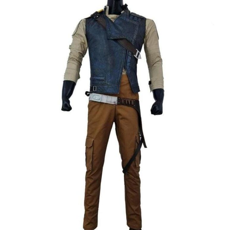 May include: A costume set comprising a blue denim vest, tan long-sleeved shirt, and brown cargo trousers. The vest has an asymmetrical design with a brown strap. The trousers have multiple pockets and a belt. Black gloves complete the outfit.